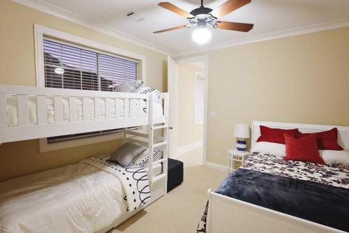 a bedroom with a white bunk bed and a ceiling fan at Downtown Museum District, Zoo, Parks, Nightlife! - Detering in Houston