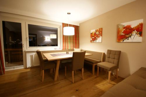 a dining room with a table and chairs and a window at Soldanella in Lech am Arlberg