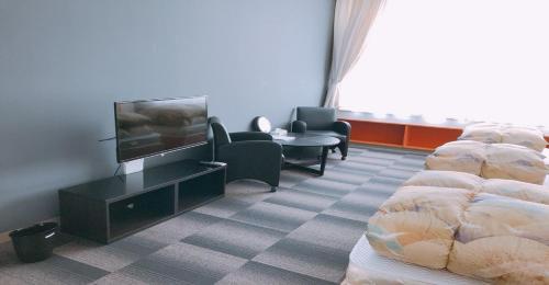 a hotel room with two beds and a flat screen tv at KIBOTCHA / Vacation STAY 8354 in Higashimatsushima