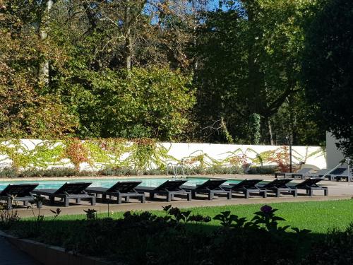 a row of benches sitting in a park at Hotel Balneario De Alceda in Alceda