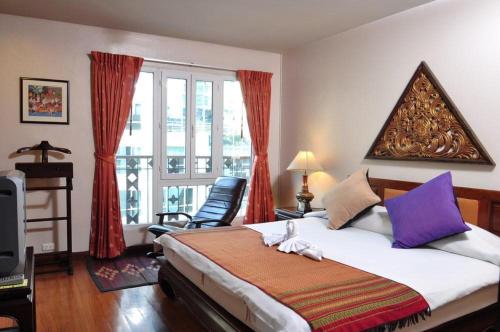 Tempat tidur dalam kamar di The Siam Heritage Hotel