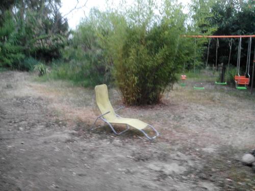 a plastic chair sitting in the middle of a yard at Mas de l'Olivier in Saint-Estève