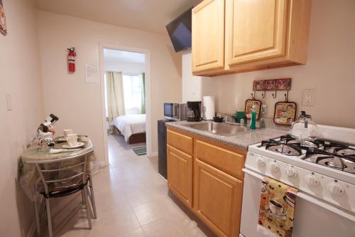 a kitchen with a stove top oven next to a sink at STUDIO&ONE BEDROOM APARTMENTS in Bronx
