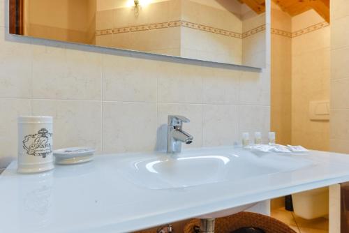 a bathroom with a white sink and a mirror at Villa dei Venti - Comfort Holiday in Bergamo