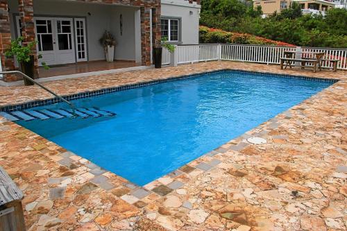 a swimming pool with blue water in a yard at CosyNest in Basseterre