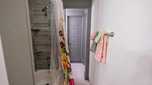 a bathroom with a shower and a shower curtain at Galleria Area Condo, 2 Bedrooms 2 Story - Ocee in Houston