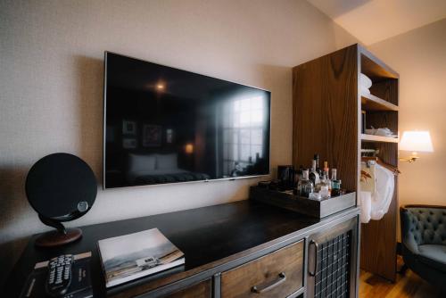 a living room with a large flat screen tv on the wall at The Ramble Hotel in Denver
