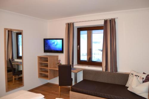 a living room with a couch and a window at Gästehaus Elisabeth in Radstadt