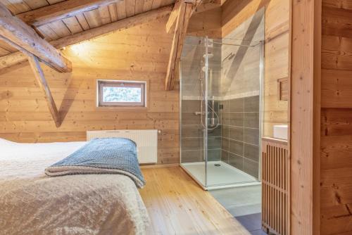 a bedroom with a shower and a bed in a room at Le Charmélie 1600 in Flaine