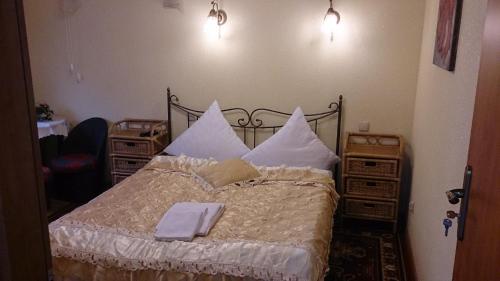a bedroom with a bed with white sheets and pillows at Villa Europa in Mielno