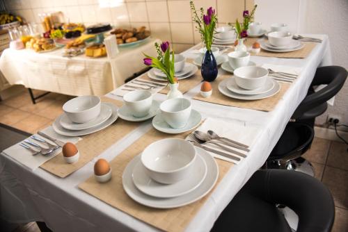 a long table with plates and eggs on it at B&B Gabriela Amsterdam in Amsterdam