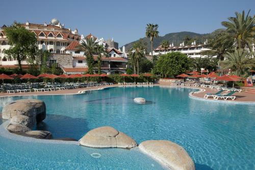 a large swimming pool with rocks in the water at Marti Resort Deluxe Hotel in Marmaris