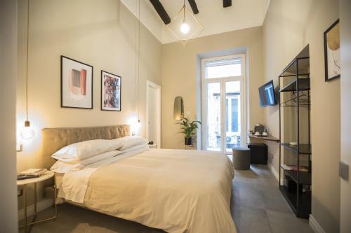 a bedroom with a large bed and a window at Bellini Suite in Naples