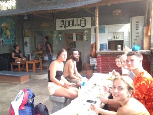 a group of people sitting at a table at Apollo Hostel in Lovina