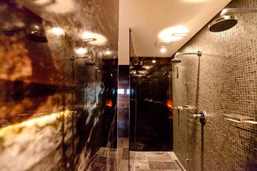 a bathroom with a shower and a glass shower stall at Ferienpension Senfter in Innervillgraten