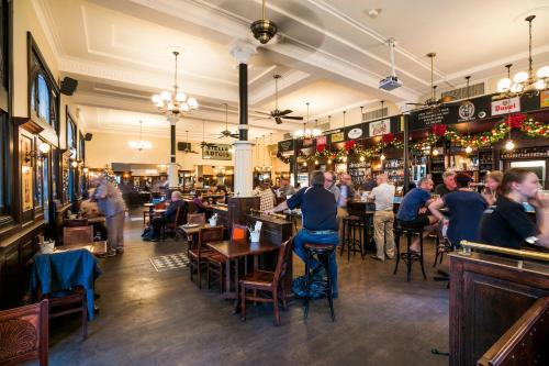 a group of people sitting at tables in a restaurant at Nightcap at Belgian Beer Cafe in Perth