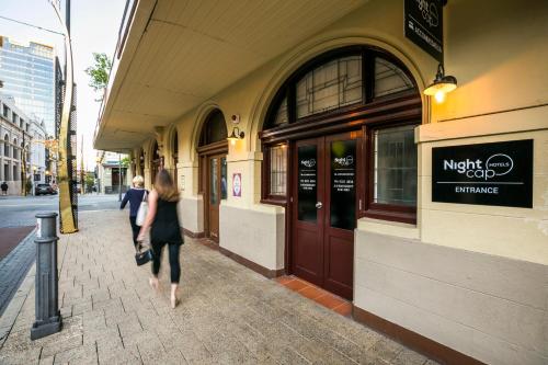 two women walking down a sidewalk in front of a building at Nightcap at Belgian Beer Cafe in Perth