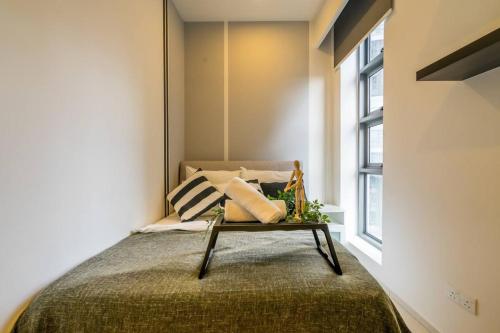 a bedroom with a bed and a window at The Robertson Residences in Kuala Lumpur