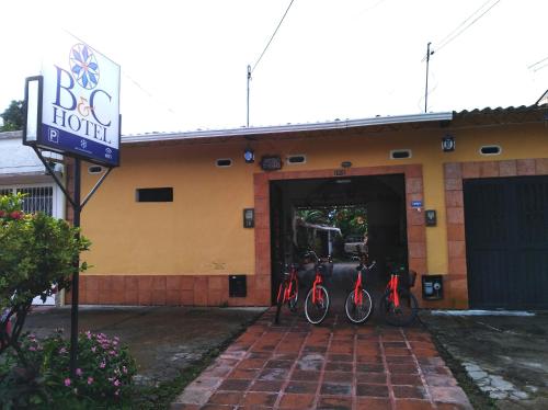 a group of bikes parked outside of a building at Hotel B & C in Mariquita