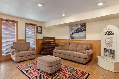 a living room with two couches and a tv at Super 8 by Wyndham Waco University Area in Waco