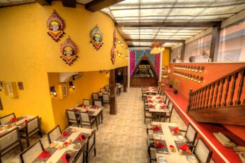 an overhead view of a restaurant with tables and chairs at Goldfinch Hotel Bangalore in Bengaluru