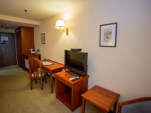 TV a/nebo společenská místnost v ubytování Jiuwu Hotel