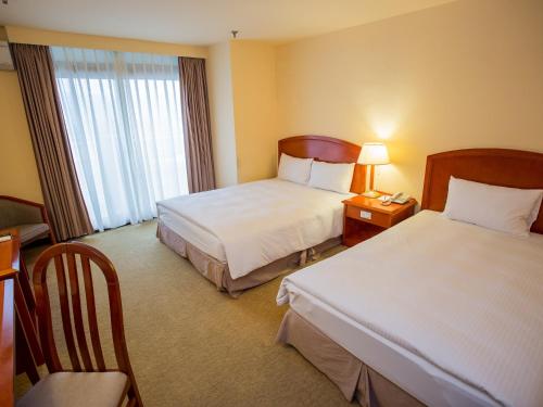 Postel nebo postele na pokoji v ubytování Jiuwu Hotel