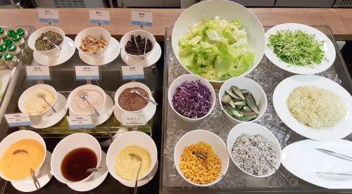 a display case with different kinds of food in bowls at Just Sleep Hualien ZhongZheng in Hualien City