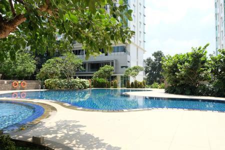 an empty swimming pool in front of a building at Premium One Bedroom at Woodland Park Residence in Jakarta