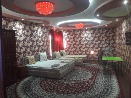 a room with a bed and a table in it at HOtel Like in Samarkand