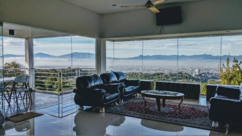 a living room with a couch and a table at Villa Rosvita Bandung in Lembang