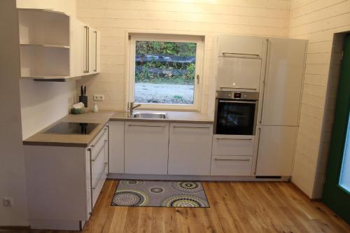a kitchen with white appliances and a window at Ferienhaus 59 in Kinding