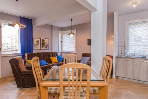 a dining room and living room with a table and chairs at Colorful Two Bedroom Apartment next to Serdika Center Sofia in Sofia