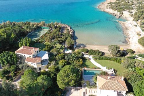 an aerial view of a house next to the ocean at Villa Iris - Luxury traditional beachfront villa with swimming pool in Koilás