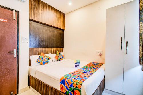a bedroom with a bed and a glass door at FabHotel Corporate Crown Koramangala in Bangalore