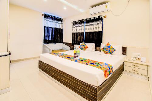 a bedroom with a large bed in a room at FabHotel Corporate Crown Koramangala in Bangalore