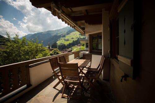 a balcony with chairs and a table with a view at Landhaus Erlzette in Tux