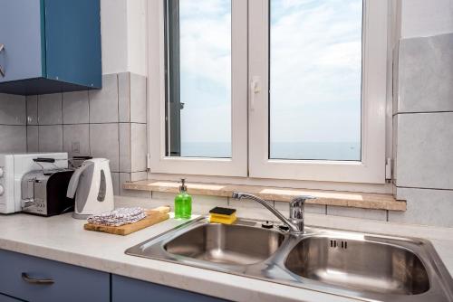 a kitchen counter with a sink and a window at Villa Gloria in Potomje