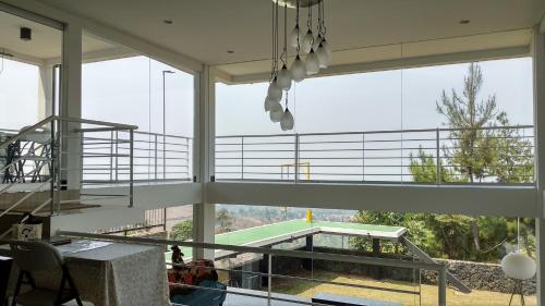 a large room with large windows and a tennis court at Villa Rosvita Bandung in Lembang