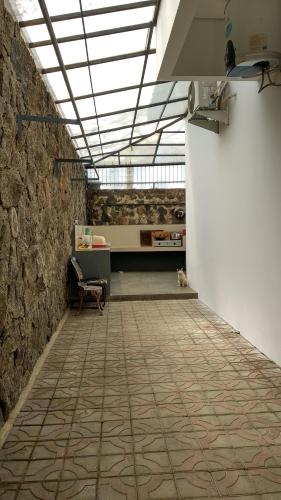 a room with a stone wall and a bench in a room at Villa Rosvita Bandung in Lembang