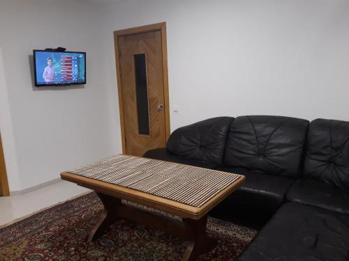 a living room with a couch and a table at Centras in Kėdainiai