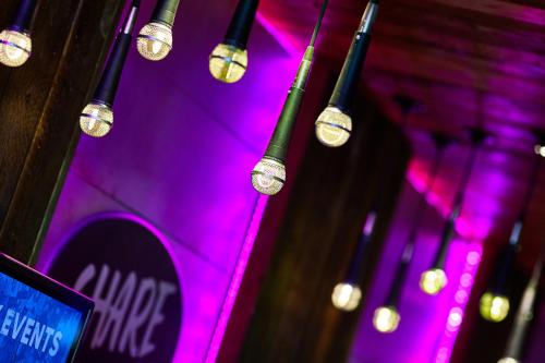 a bunch of lights hanging from a wall with purple lights at St Christopher's Inn London Bridge - Oasis Female Only in London