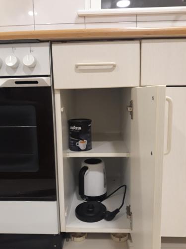 a coffee maker is inside of a kitchen cabinet at Centras in Kėdainiai