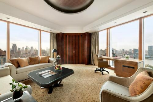 a living room with a view of a city at Pudong Shangri-La Shanghai - With a sweeping view of the Pearl Tower and the historic Bund skyline in Shanghai