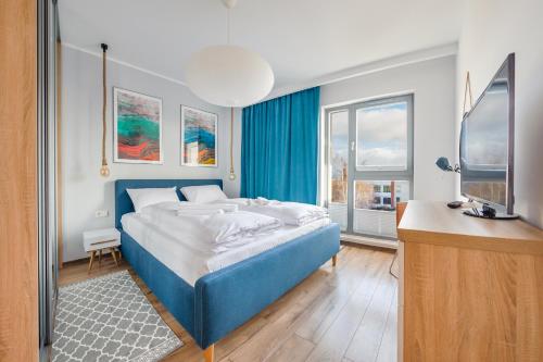 מיטה או מיטות בחדר ב-Apartamenty Sun & Snow Nadmorze