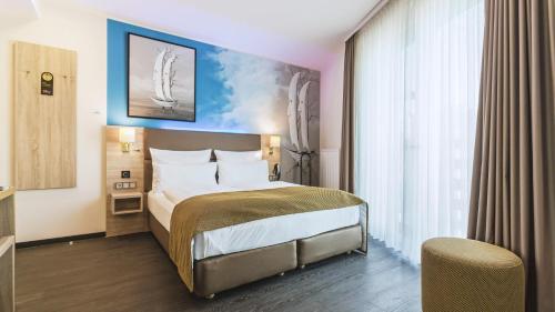 En eller flere senge i et værelse på Stay! Hotel Boardinghouse