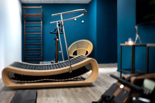 a bench in a room with a blue wall at Hôtel Les Deux Girafes in Paris