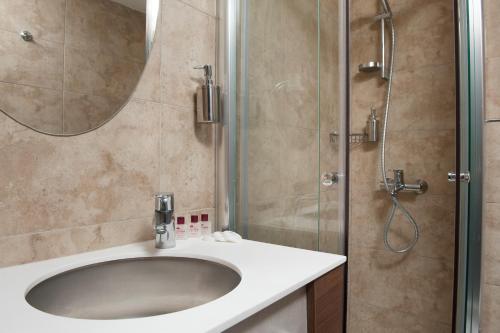 a bathroom with a sink and a shower at Birbey Hotel in Istanbul