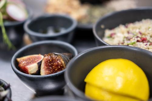 a table with bowls of food and a lemon at Elite Athlete Centre and Hotel in Loughborough