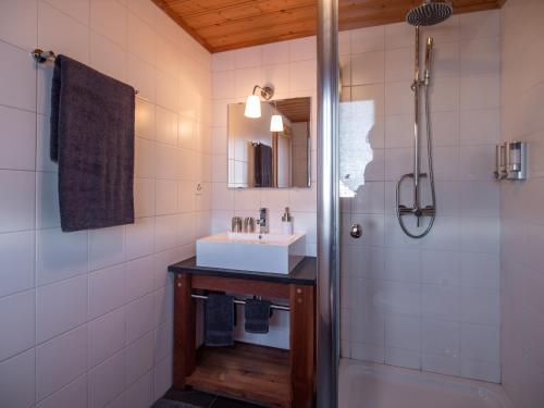 a bathroom with a sink and a shower at Hotel Edelweiss in Nendaz